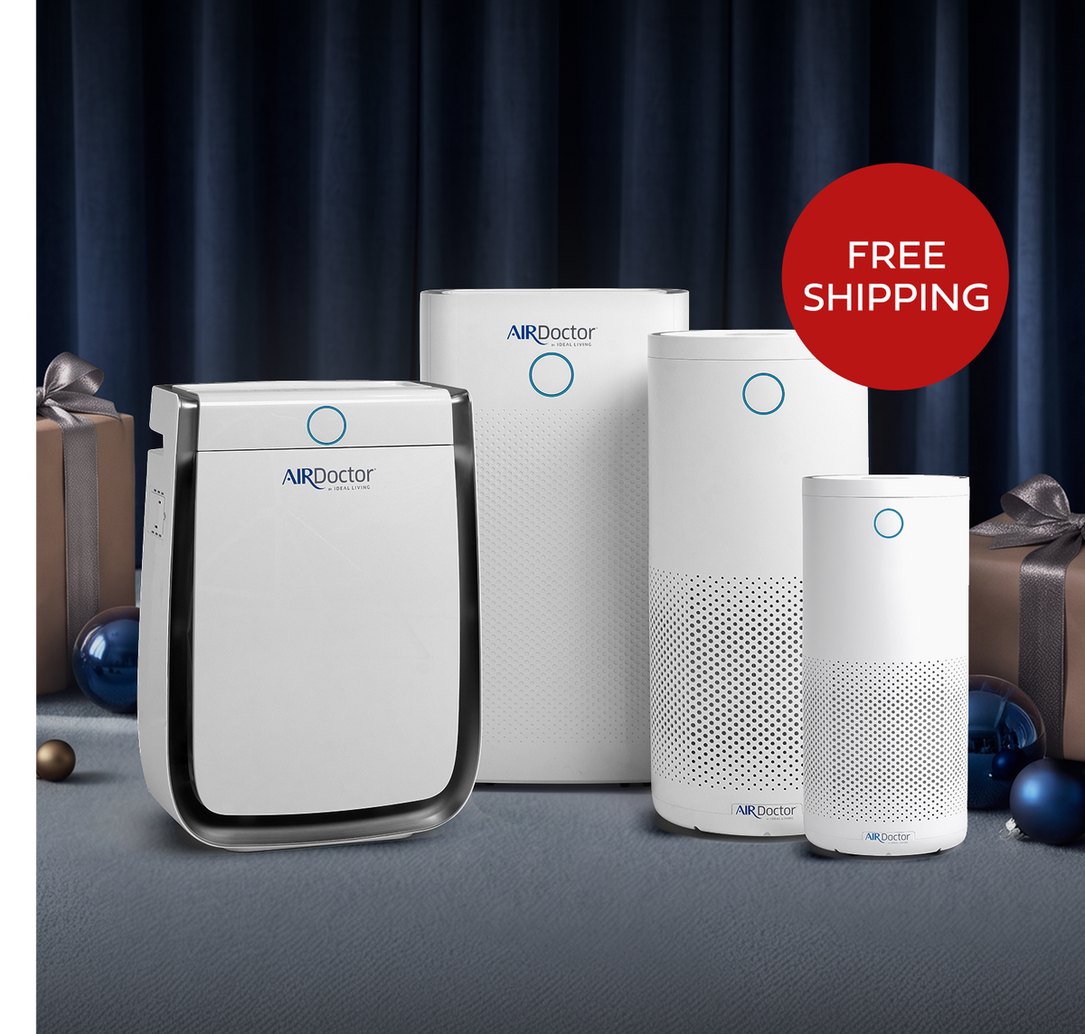 Four AirDoctor Air Purifiers standing in front of a blue curtain